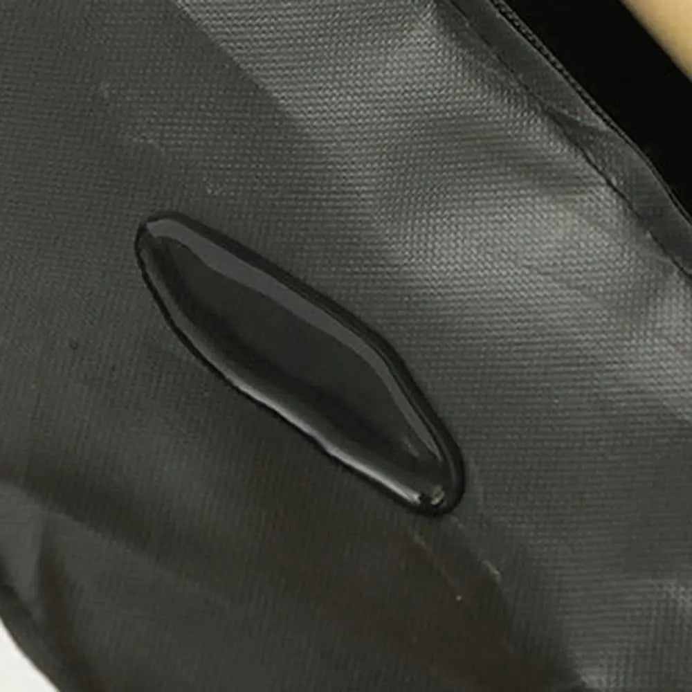 Close-up of a black handle on a gray bag